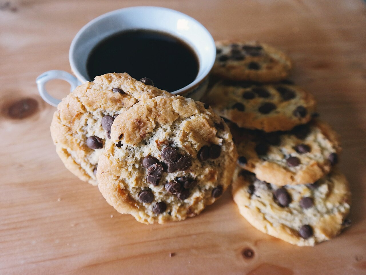 Chocolate-chip cookies beside coffee